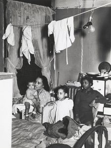 Negro family living in crowded quarters, Chicago, Illinois, April 1941. Creators: Farm Security Administration, Russell Lee.