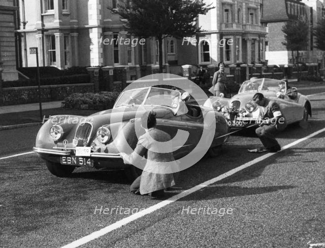Officials measuring Jaguar XK120, 8 clubs rally Eastbourne 1952. Reg EBN 514. Creator: Unknown.