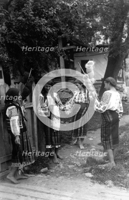 Young women spinning wool, Bistrita Valley, Moldavia, north-east Romania, c1920-c1945. Artist: Adolph Chevalier