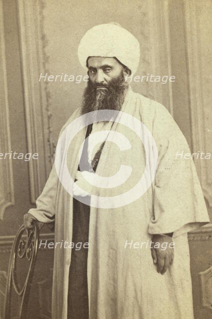 Three-quarters length portrait of a mullah(?), facing left, between 1870 and 1886. Creator: Unknown.