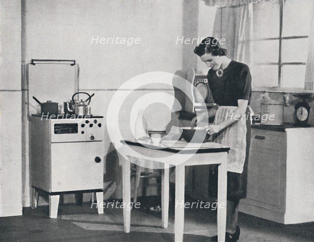 'A British kitchen equipped with a cabinet gas cooker', 1942.  Artist: Unknown.