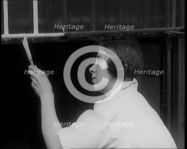 Female Civilian Painting a Building, 1931. Creator: British Pathe Ltd.