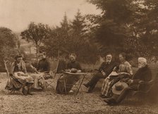 'A group of men and women sat talking by a table', 1937. Artist: Louis Guichard.