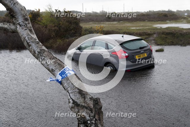 Ford Focus in flooded ditch after losing control on wet road 2012 Artist: Unknown.