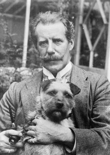 Bernard M. Partridge holding dog, 1910. Creator: Bain News Service.
