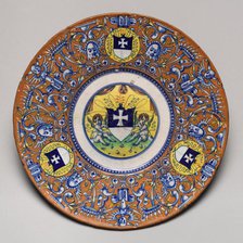 Plate with border of grotesques on an orange ground and three shields..., probably c1510/1525. Creator: Unknown.