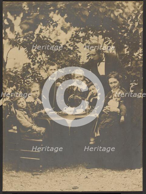 Group portrait around table, 1880-1890. Creator: Victor Dix.
