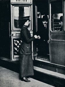 A woman ticket inspector at work, c1914. Artist: Unknown
