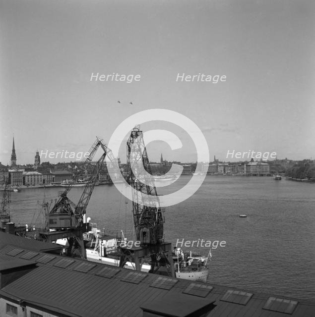 Lifting cranes at the city courtyard, Stockholm harbour, Sweden, 1950. Creator: Unknown.