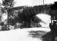 FIAT of Luigi Storero going under a bridge during the 1904 Gordon Bennett Cup, Homburg, Germany. Creator: Unknown.