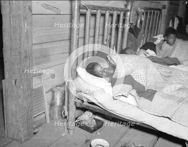 Sick flood refugee in the Red Cross temporary infirmary at Forrest City, Arkansas, 1937. Creator: Walker Evans.