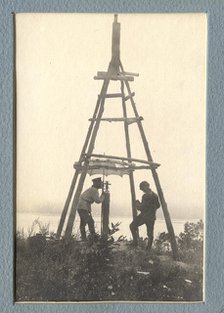 The moment of carrying out triangulation measurements under a tower on the river bank, 1909. Creator: Vladimir Ivanovich Fedorov.