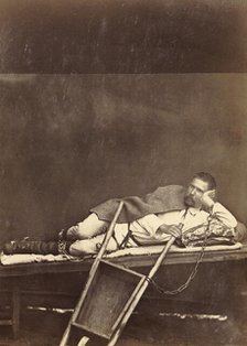 Hard Labor Convict Lying on a Bunk While Chained to a Wheelbarrow, 1891. Creator: Aleksei Kuznetsov.