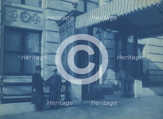 Two men, one a doorman, standing at the F. Street entrance to the Willard..., between 1901 and 1910. Creator: Frances Benjamin Johnston.