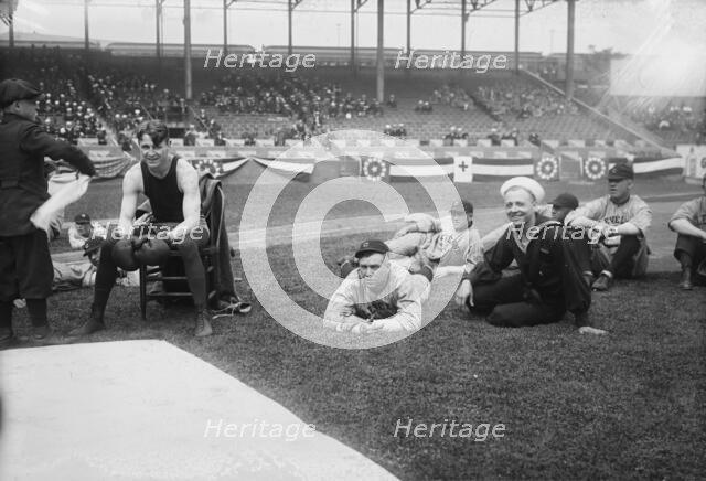 Boxer Joe Welling, amid Cleveland baseball players in stadium, 1918. Creator: Bain News Service.
