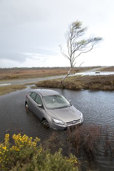 Ford Focus in flooded ditch after losing control on wet road 2012 Artist: Unknown.