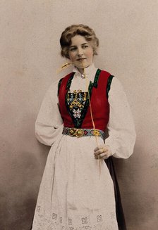 A young Norwegian woman, posing in a photographic studio wearing peasant dress, 1903. Creator: Solveig Lund.