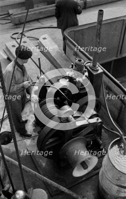 A winchman at work on the River Thames, London, c1945-c1965. Artist: SW Rawlings