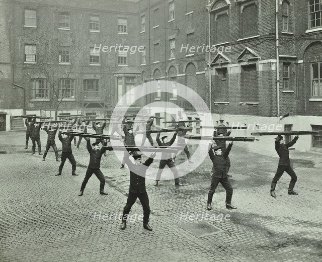 Firemen carrying out scaling ladder drill, London Fire Brigade Headquarters, 1910. Artist: Unknown.