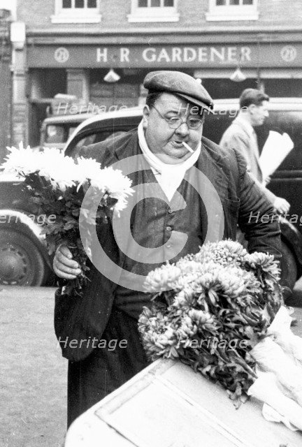 A London flower seller, Covent Garden Market, 1952. Artist: Henry Grant
