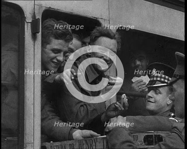 British Soldiers Receiving Food and Drink on the Train Back To Camp, 1940. Creator: British Pathe Ltd.