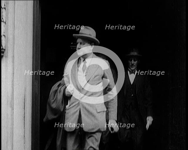 Two Male Civilians Emerging from a Building, 1924. Creator: British Pathe Ltd.