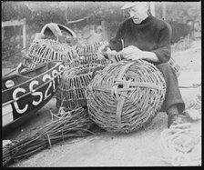 A fisherman making lobster pots at Steephill Cove, Ventnor, Isle Of Wight, 1930-1950. Creator: George R Long.
