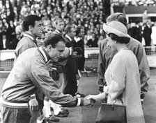 Queen Elizabeth II shaking hands with England footballer George Cohen, World Cup, Wembley, 1966. Artist: Unknown
