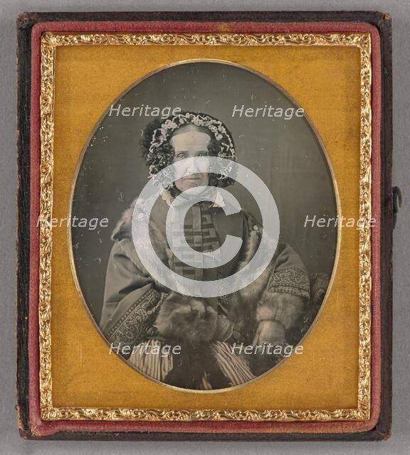 Portrait of an elderly woman wearing a hat, fur coat and gloves, seated, about 1855. Creator: Unknown.