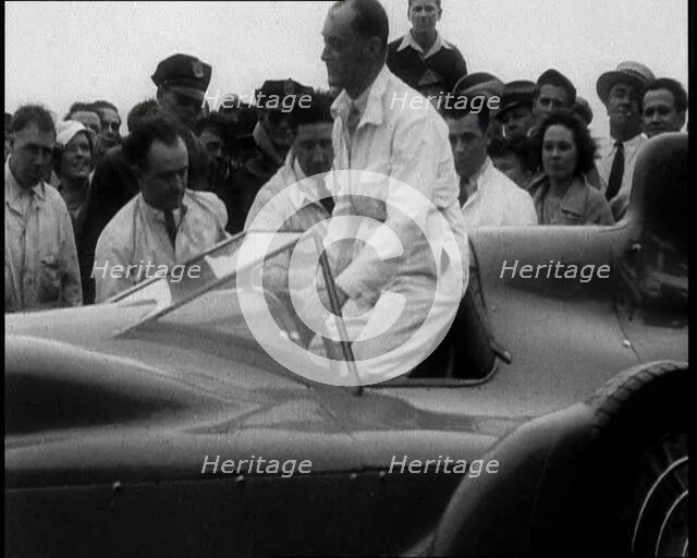 Malcolm Campbell Entering a Car While a Crowd Watches, 1933. Creator: British Pathe Ltd.