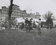 Children jumping rope on the White House lawn during annual Easter egg roll with State, War...1898. Creator: Frances Benjamin Johnston.