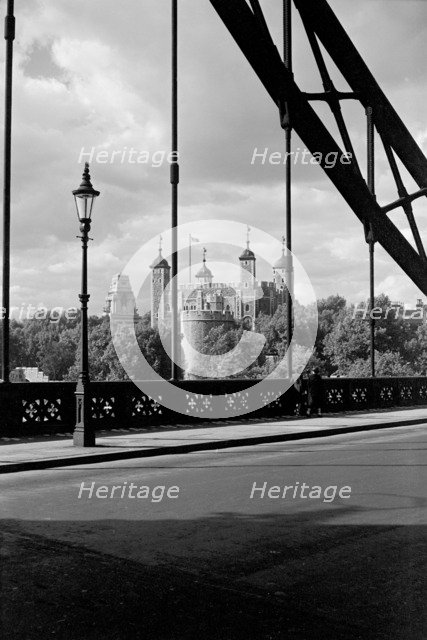 The Tower of London, viewed here through the cable supports of Tower Bridge, c1945-c1965. Artist: SW Rawlings