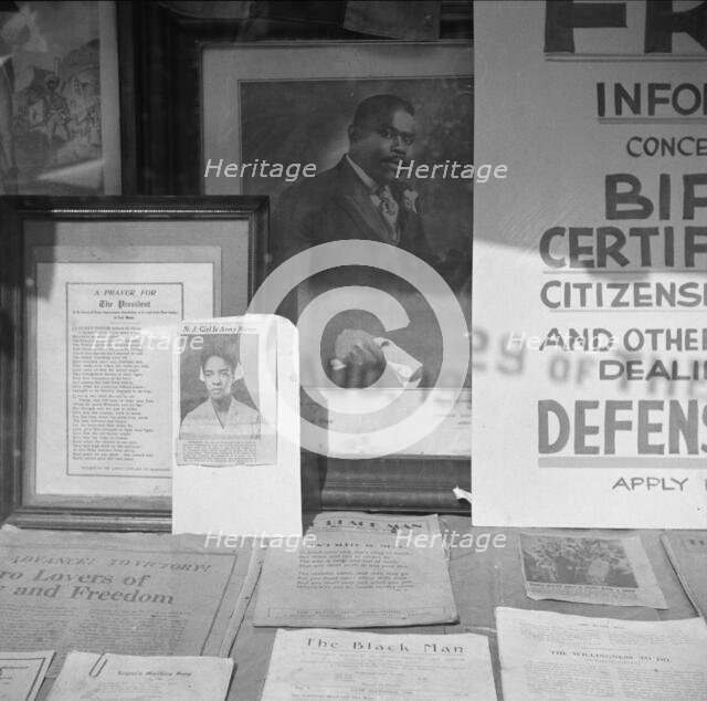 Signs in the windows of a Marcus Garvey club in the Harlem area, 1943. Creator: Gordon Parks.