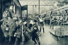 'Wounded in War Arriving at Waterloo Station, London, as an Outward Troop Train Leaves', 1915. Creator: Unknown.