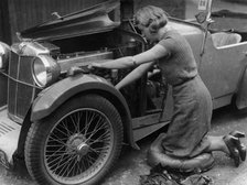 Kitty Brunell working on her MG F Magna. Artist: Unknown