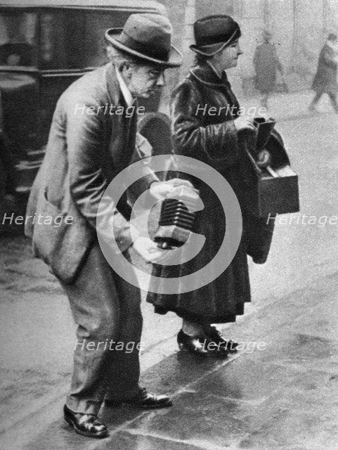 Kerb-side concertina-player, Holborn, London, 1926-1927. Artist: Unknown