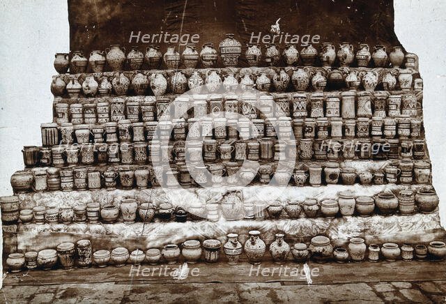 Rows of decorated pharmacy jars and other objects, c19th century. Creator: Unknown.