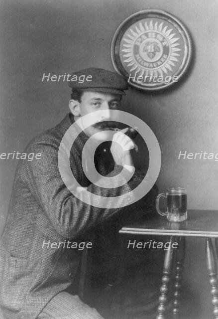 Man at table with pipe and mug under "Pabst - Milwaukee" sign - C.C. Jones, between c1890 and c1910. Creator: Frances Benjamin Johnston.