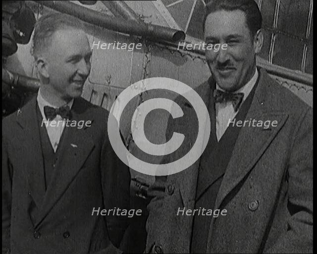 Clarence Duncan Chamberlin And Bertrand Blanchard Acosta Talking in Front of an Airplane, 1920s. Creator: British Pathe Ltd.