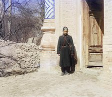 Policeman standing in front of doorway, between 1905 and 1915. Creator: Sergey Mikhaylovich Prokudin-Gorsky.