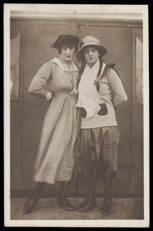 Two men, both in drag, pose wearing hats and make-up, c1918. Creator: Unknown.