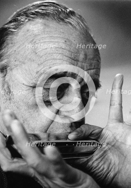 Larry Adler (1914-2001), Musician, playing his harmonica, 1992. Artist: Unknown