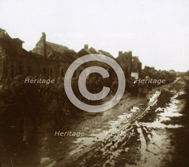 Soldiers marching past bombed-out houses, Champagne, northern France, c1914-c1918. Artist: Unknown.