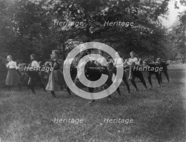 Classroom scenes in Washington, D.C. public schools - outdoor exercise with rods..., (1899?). Creator: Frances Benjamin Johnston.