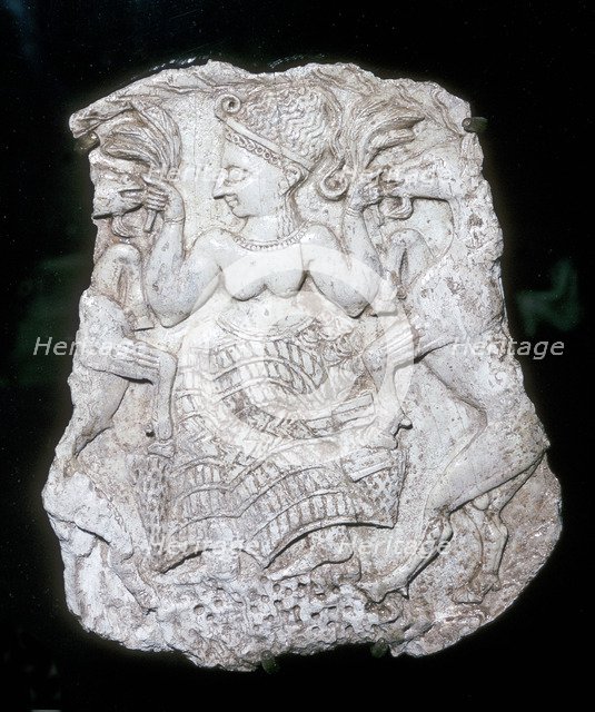 Ivory cosmetic box cover depicting a goddess feeding caprids, Tomb at Minet-el-Beida, c1250 BC. Artist: Unknown