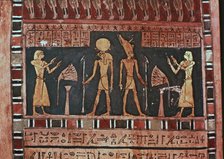 Stela in wood representing the deceased Ba-s-Turefi before the god Atum and Ra-Haharchte, from Th…