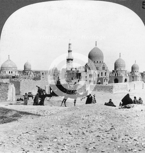 'A 'Ship of the Desert' passing tombs of by-gone Moslem rulers, Cairo, Egypt', 1905.Artist: Underwood & Underwood