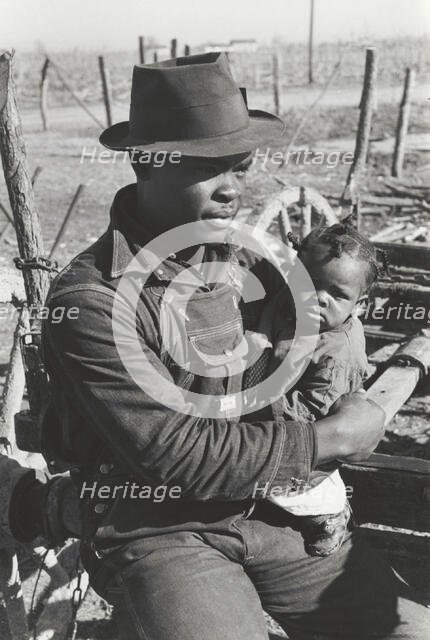Negro sharecropper and son who will be resettled, Transylvania Project, Louisiana, Jan 1939. Creators: Farm Security Administration, Russell Lee.