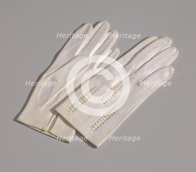 Pair of light cream gloves with openwork design from Mae's Millinery Shop, 1941-1994. Creator: Van Raalte.