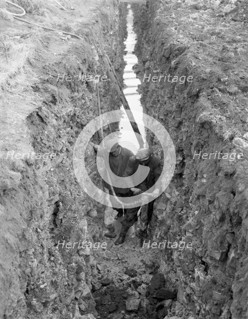 Civil engineers in a trench with a pneumatic drill, Oldcoats, Nottinghamshire, 1961. Artist: Michael Walters